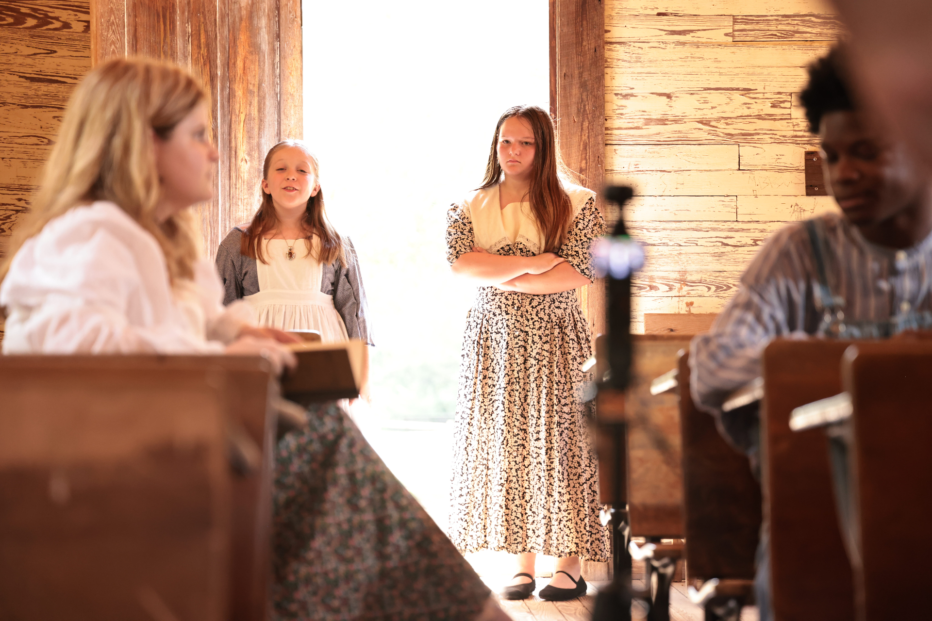 A dramatic scene inside a wooden church during filming