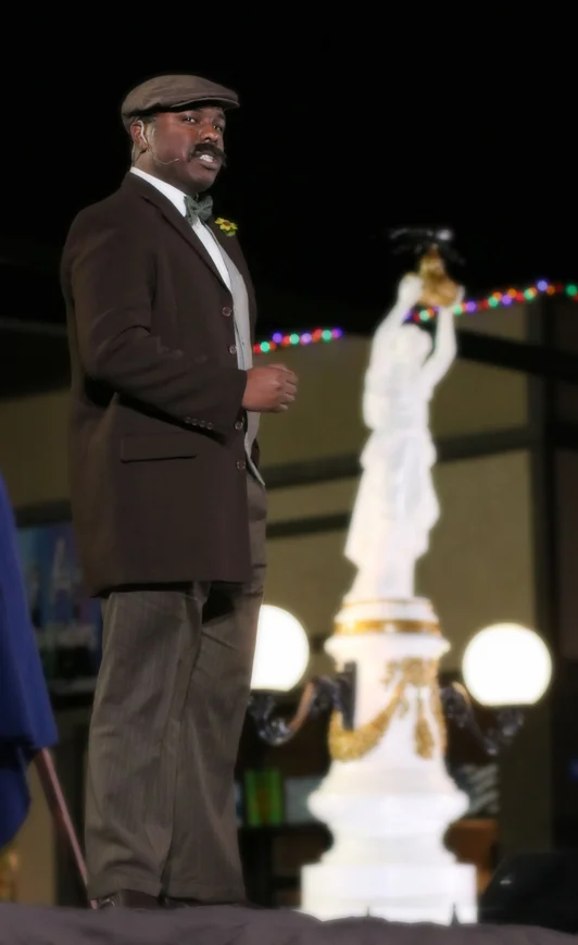 A performer in costume on the Southern Broadway stage