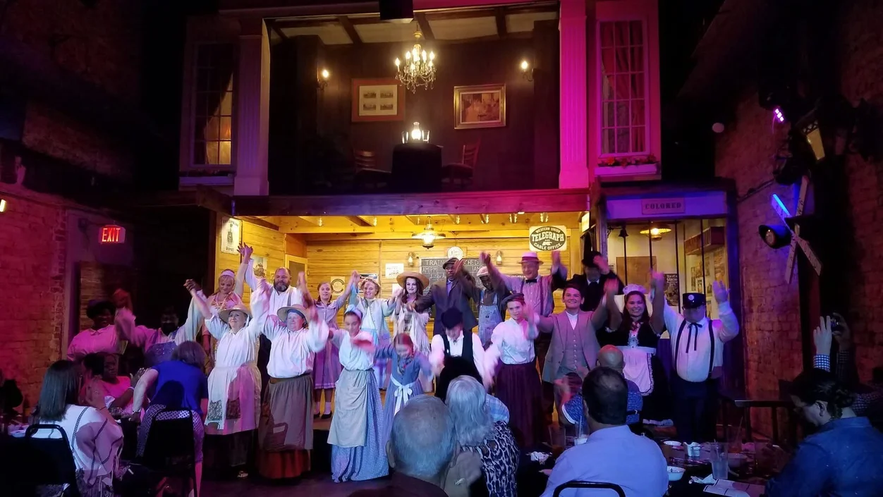 The full ensemble cast taking a curtain call